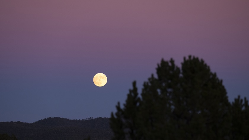 A nearly-full moon rises over the hills surrounding the Village of Ruidoso. Photo by Zach Ryall.