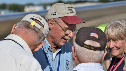 Tom Reilly (at left center in blue shirt), who led the restoration of the prototype XP-82 to pristine condition, talks with visitors to EAA AirVenture Oshkosh 2019. Photo by Mike Collins.