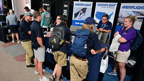 AmeriFlight staff talk with other aviation career specialists in the EAA AirVenture Oshkosh Careers and Education center in 2021. Photo by David Tulis.
