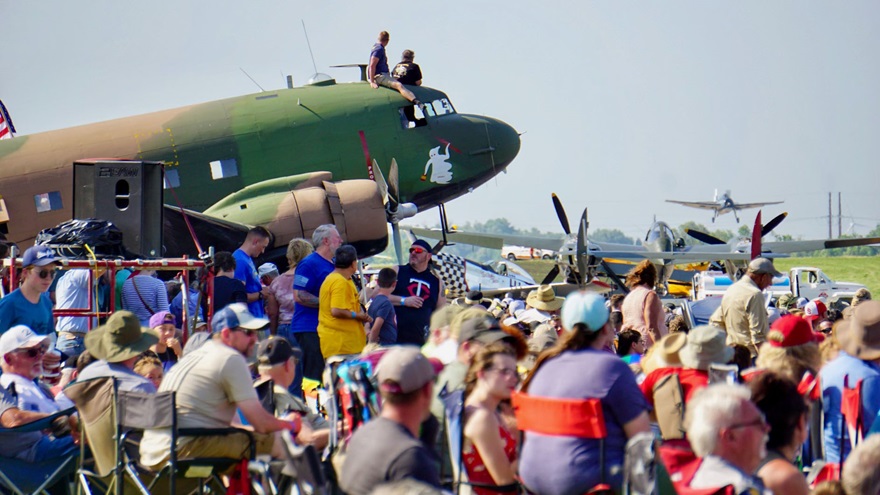 C–47 crew members sit atop their aircraft for prime airshow viewing. Photo by Cayla McLeod Hunt.