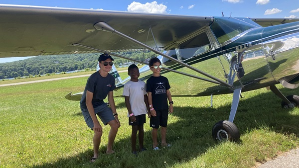 After a flight with founder and president of Young Pilots USA Luc Zipkin, two young aviation enthusiasts are all smiles. Photo by Lillian Geil.
