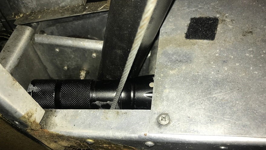 A pilot experienced rudder control issues in flight. Upon inspection, a flashlight was found wedged between the center control column and the rudder cable. Photo by Jeff Simon.