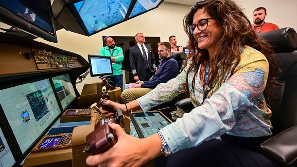Natalie Golasa of Brooklyn, New York, tries out a flat-panel flight simulator during a field trip to FedEx headquarters during the AOPA High School Aviation STEM Symposium in Memphis, Tennessee, November 14. Photo by David Tulis.
