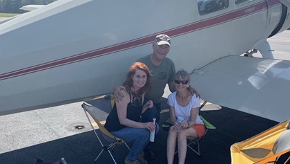Jim and Eileen Wilson greeted newly minted private pilot Kellie Brown at her home airport after Brown passed her checkride. "They had brought a bouquet of roses and a beer that I definitely needed after that day," recalled Brown. Photo courtesy of Kellie Brown.