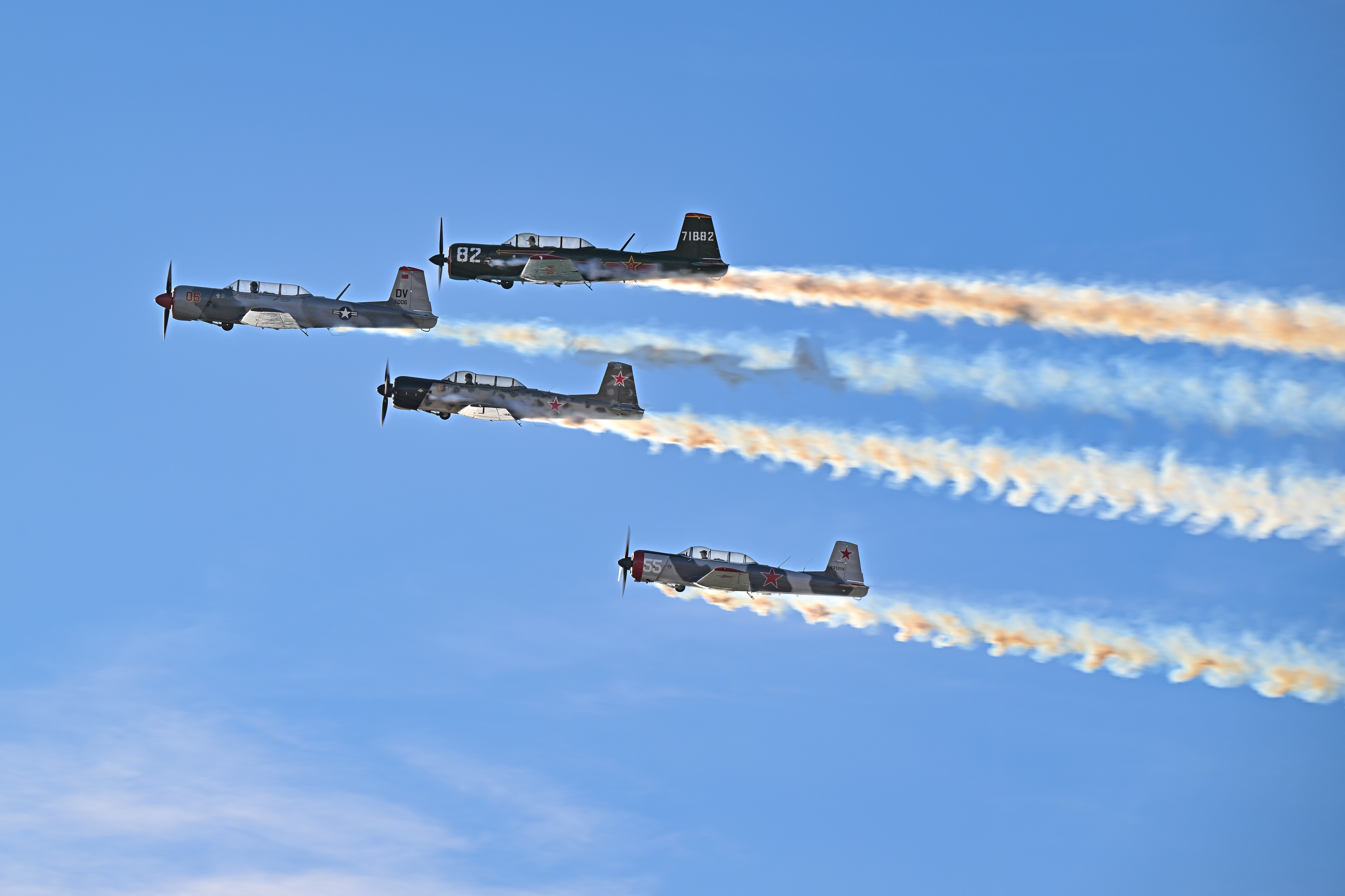 The Desert Rats perform a formation routine in front of the AOPA Flightline Chalet. Photo by David Tulis.