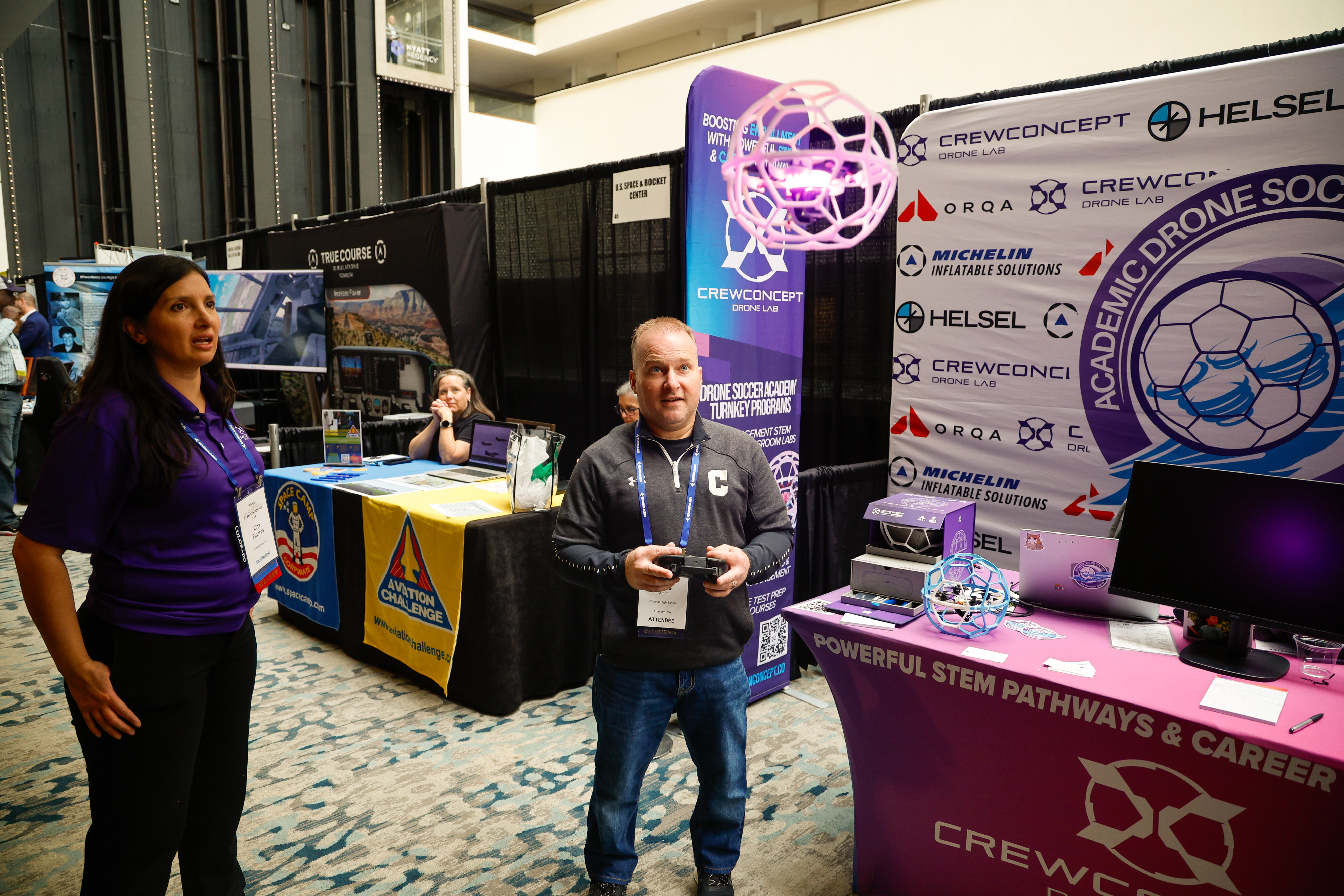 Lina Pineros with CrewConcept Inc. watches as attendee Steve Smith controls a drone. Photo by Chris Rose.