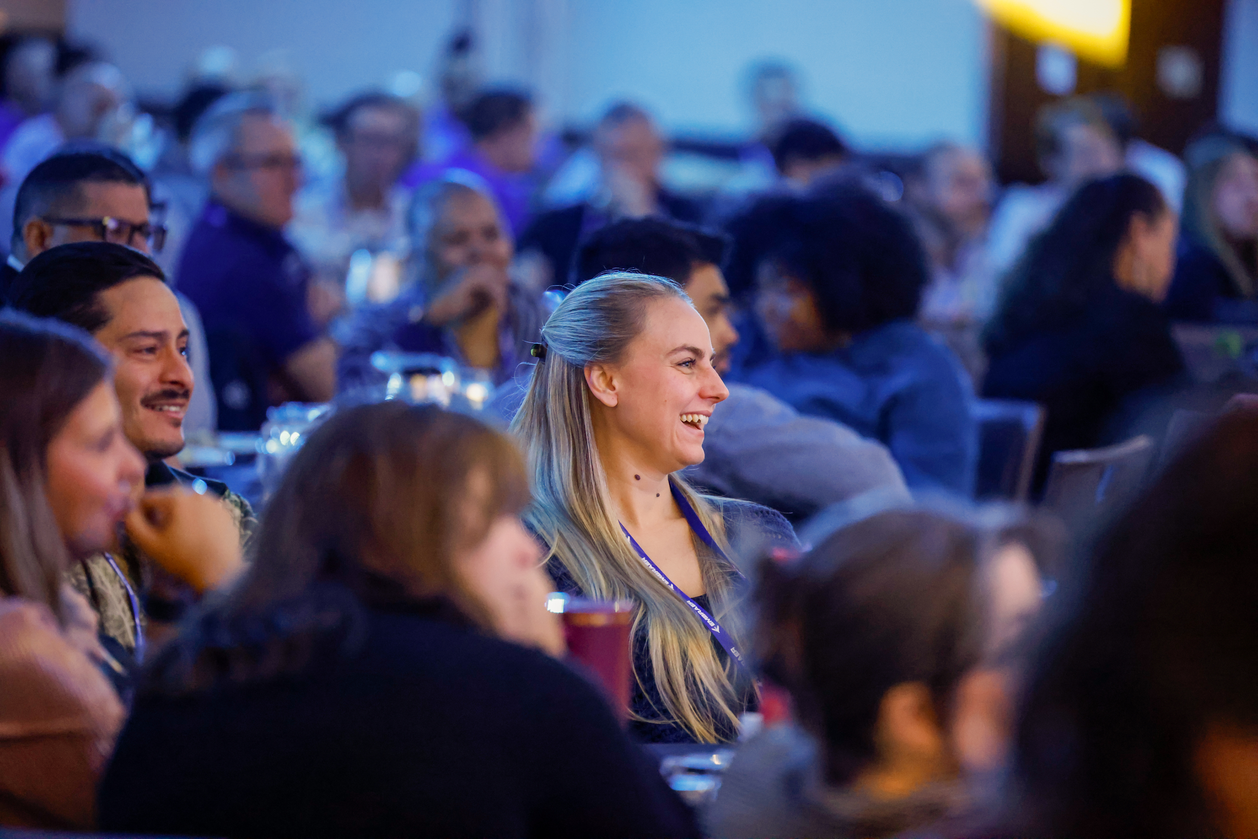 Attendees laugh during symposium presentations. Photo by Chris Rose.