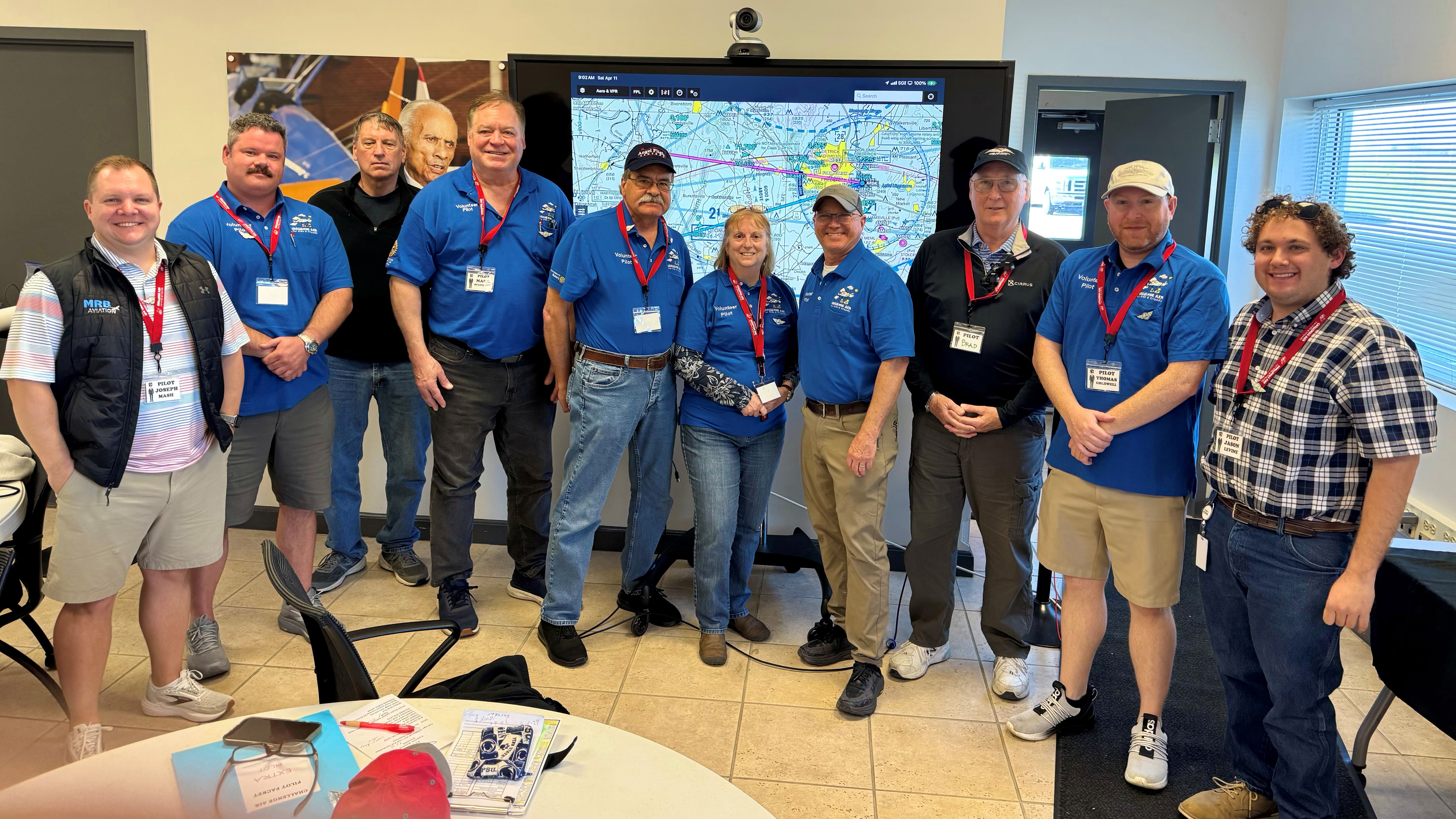 The volunteer pilots left to right: Joseph Mash, Gavin Miller, Paul Gambacorta, Mark Stapleton, Jerry Hill, Lin Caywood, Brent Anderson, Brad Docos, Thomas Coldwell, Jason Levine. Photo by Kris Lonborg. 