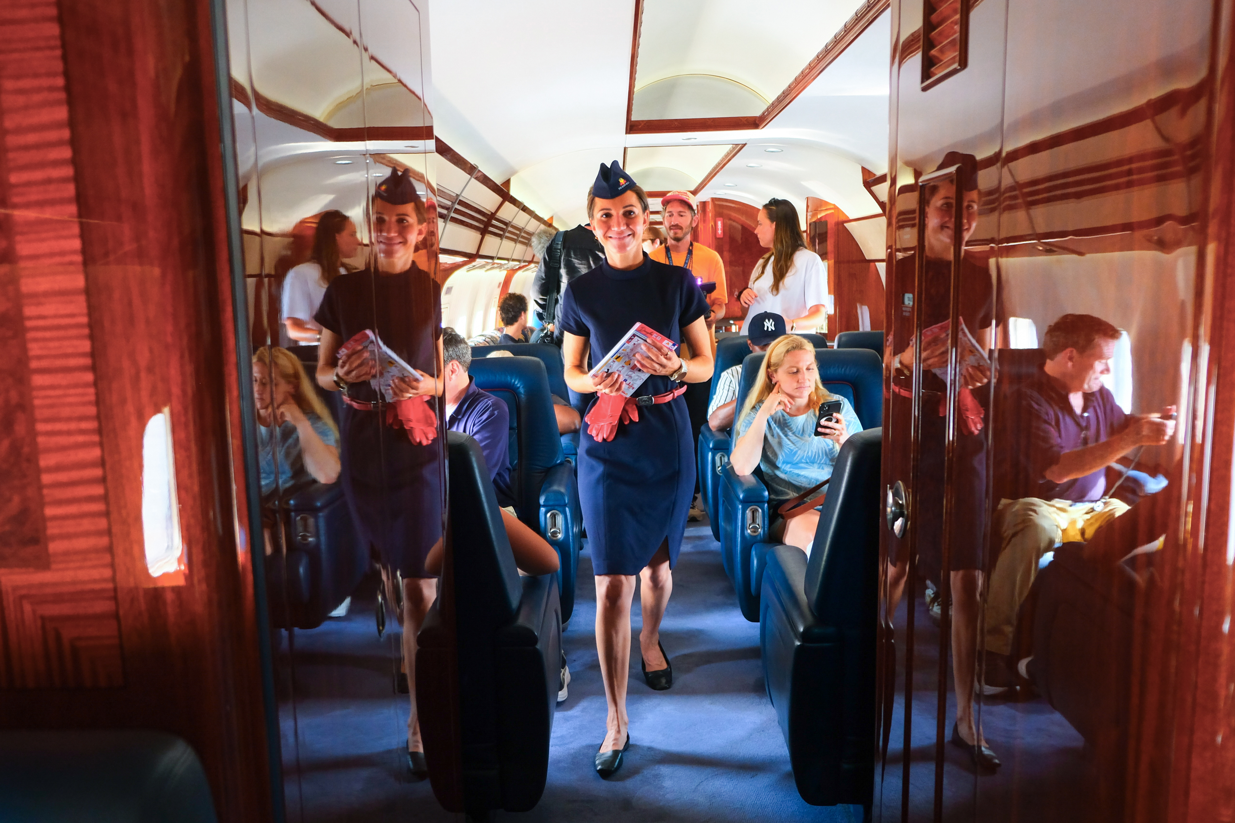 Julia Steinacher prepares for the on-board safety briefing. Every part of the experience, including flight attendant uniforms, hearkens back to the Golden Age of air travel. Photo by Alicia Herron.