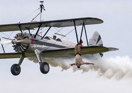 Virginia Hall of Fame inductee and Bealeton Flying Circus wing walker Charles Stanley "Chuck" Tippett performs a freestyle wing walking routine from a biplane. Photo courtesy of Warrenton-Fauquier Airport.