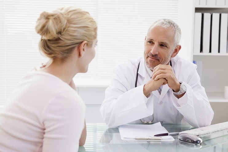 A doctor consults with a patient during a medical visit. iStock photo.              