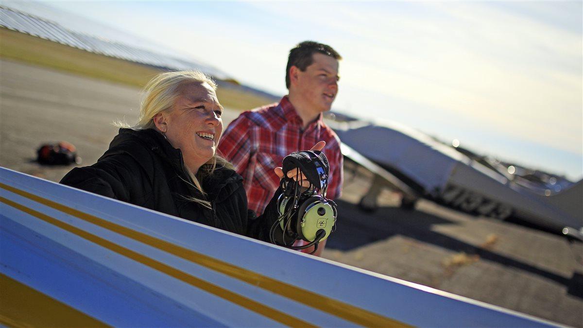 Brenda Tibbs has broadened her role as a flight instructor to include facilitating connections within the pilot community. She is shown with student pilot Niles Schuch.