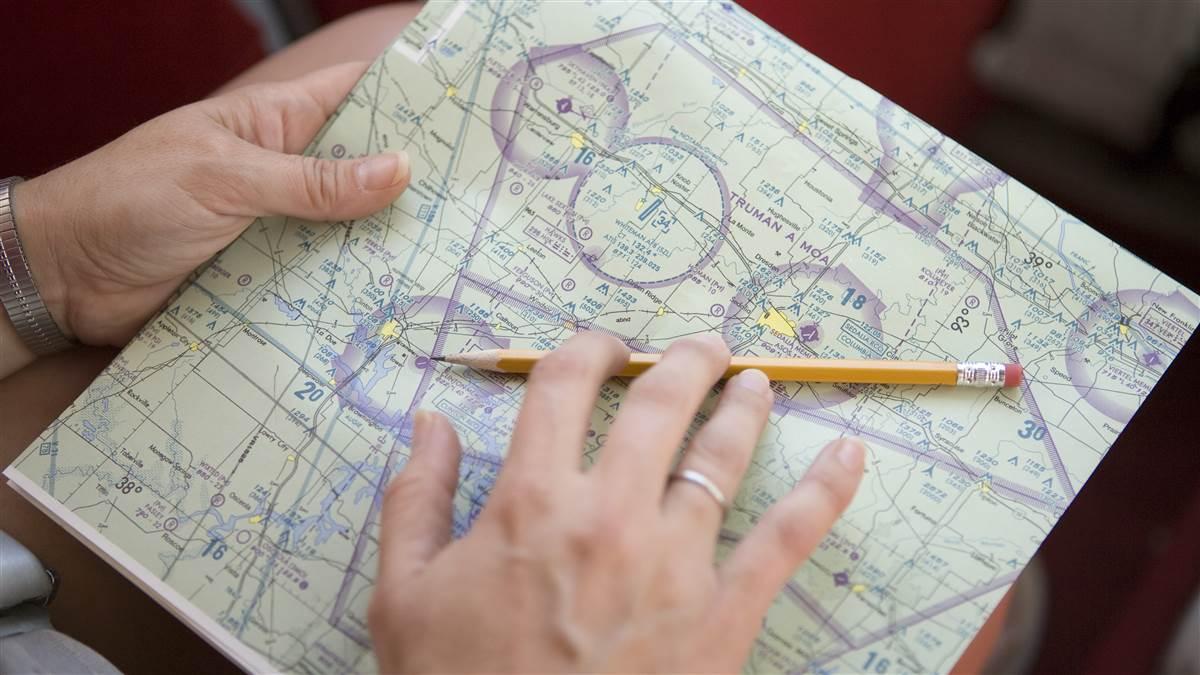 Pilot uses a pencil to quickly mark a chart.
