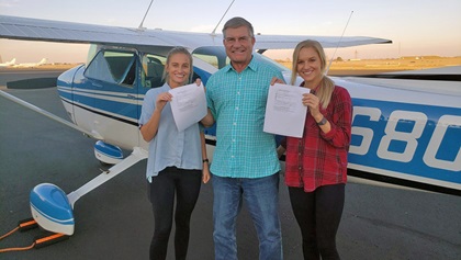 Emily (left) and Lexie Wilson with Designated Pilot Examiner Tom Gregory.