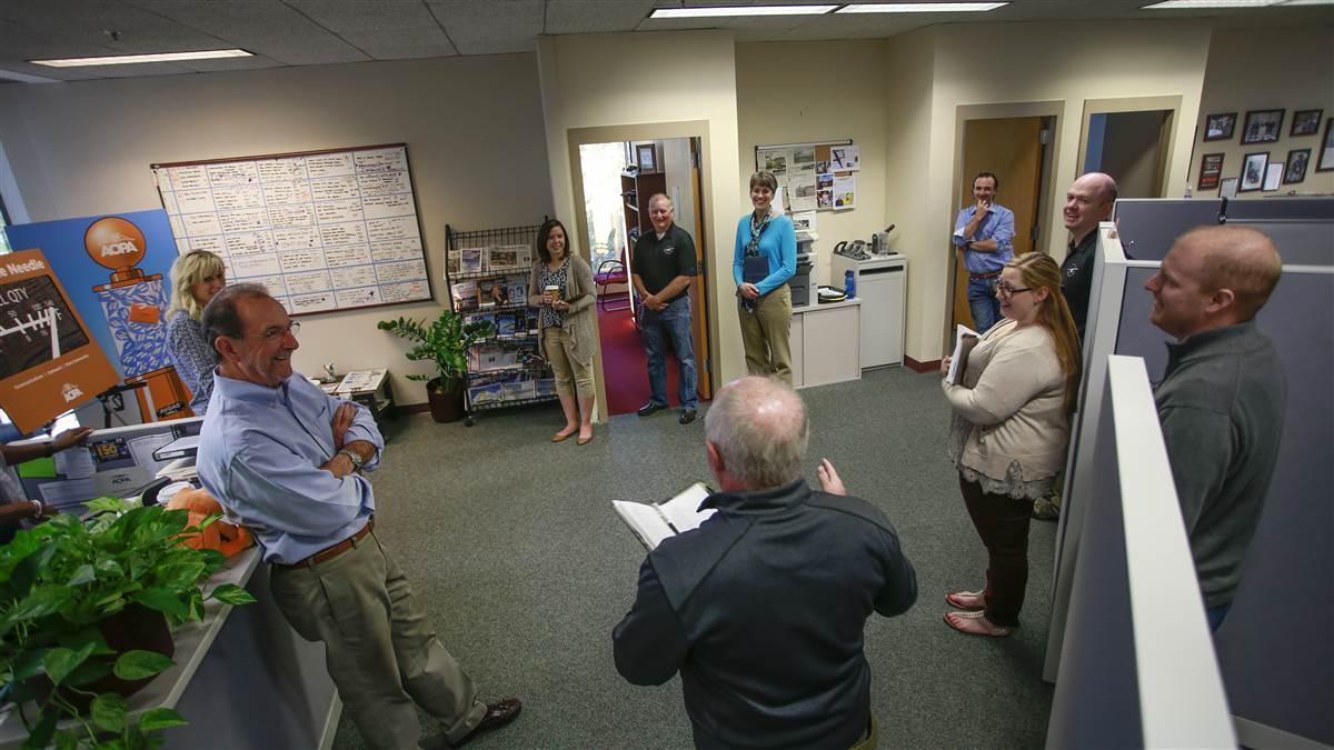 Standup morning meetings keep You Can Fly staff up to date and energized. Clockwise around the room, Les Smith (foreground, blue shirt), Senior Vice President Katie Pribyl, Meghan McCutcheon, Donald Mackay, Cindy Hasselbring, Joe Kildea, Chris Moser, Amber Kite, and 'AOPA Pilot' Editor Ian Twombly listen as Mike Woods shares news.
