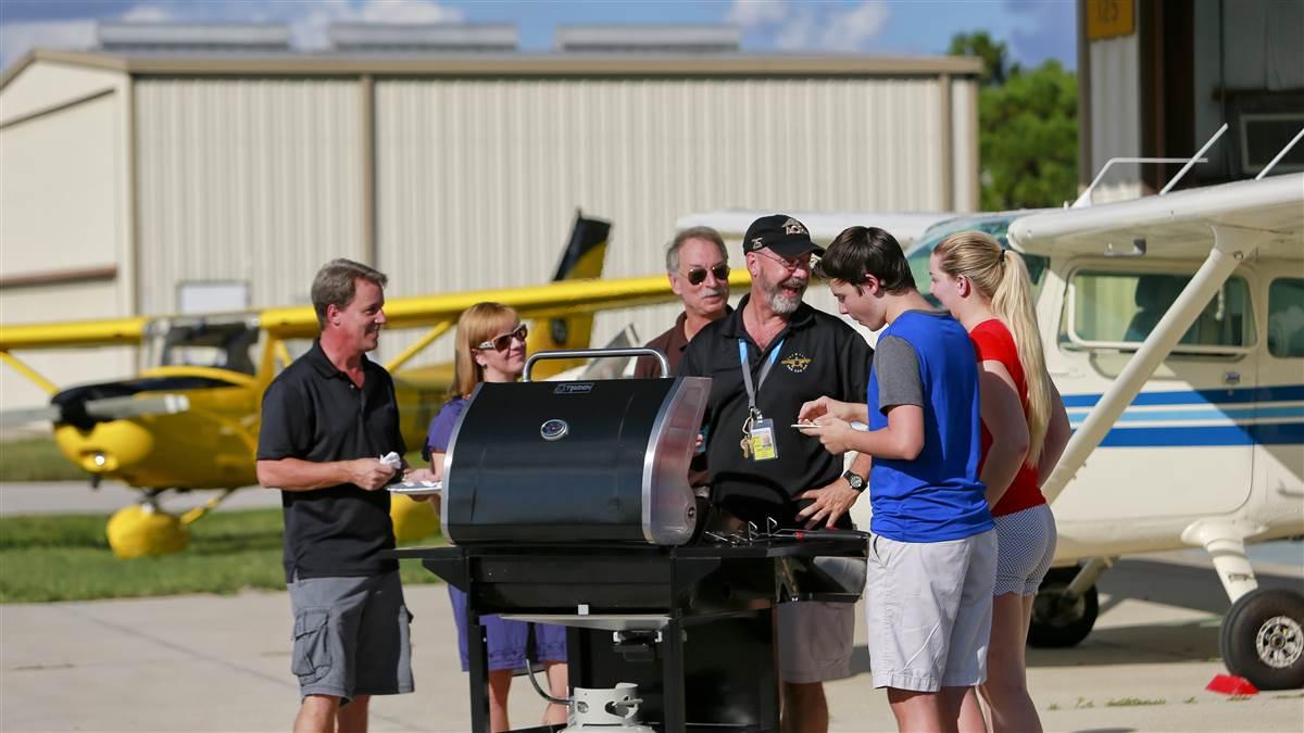Flying clubs are a hallmark of the You Can Fly program. Florida-based AOPA Ambassador Jamie Beckett mans the grill at a gathering of a flying club he helped create.