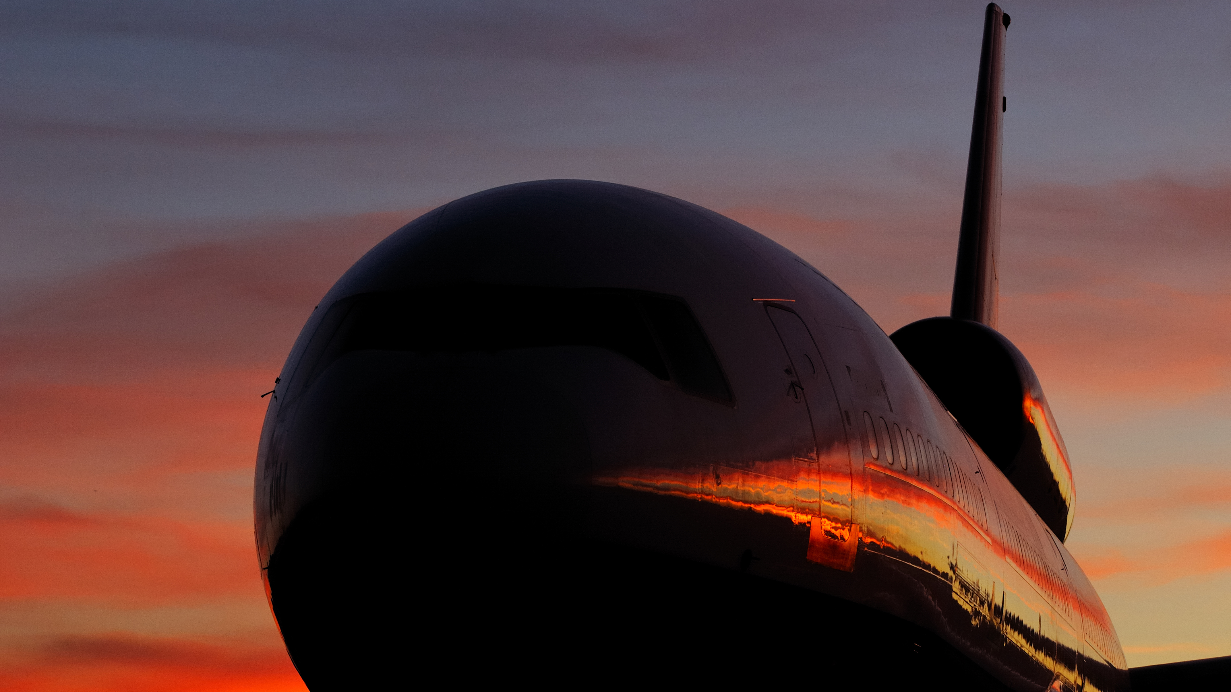"The New Rainmaker," May 2012 'AOPA Pilot': A spectacular high-desert sunset is reflected in the flanks of a Douglas DC–10 on the ramp in Victorville, California. Tanker 911, operated by 10 Tanker Air Carrier, had just completed U.S. Forest Service qualification flights for the 2012 fire season. Slowing to 140 knots, the converted airliner can drop 9,400 gallons of retardant—almost 85,000 pounds—in as few as four seconds. (Nikon D300S, 110 mm, 1/50, f/6.3, ISO 400)