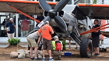 Mike Patey’s super STOL aircraft ‘Scrappy’ draws a crowd in front of the Garmin display during its public debut at EAA AirVenture July 28. Photo by David Tulis.