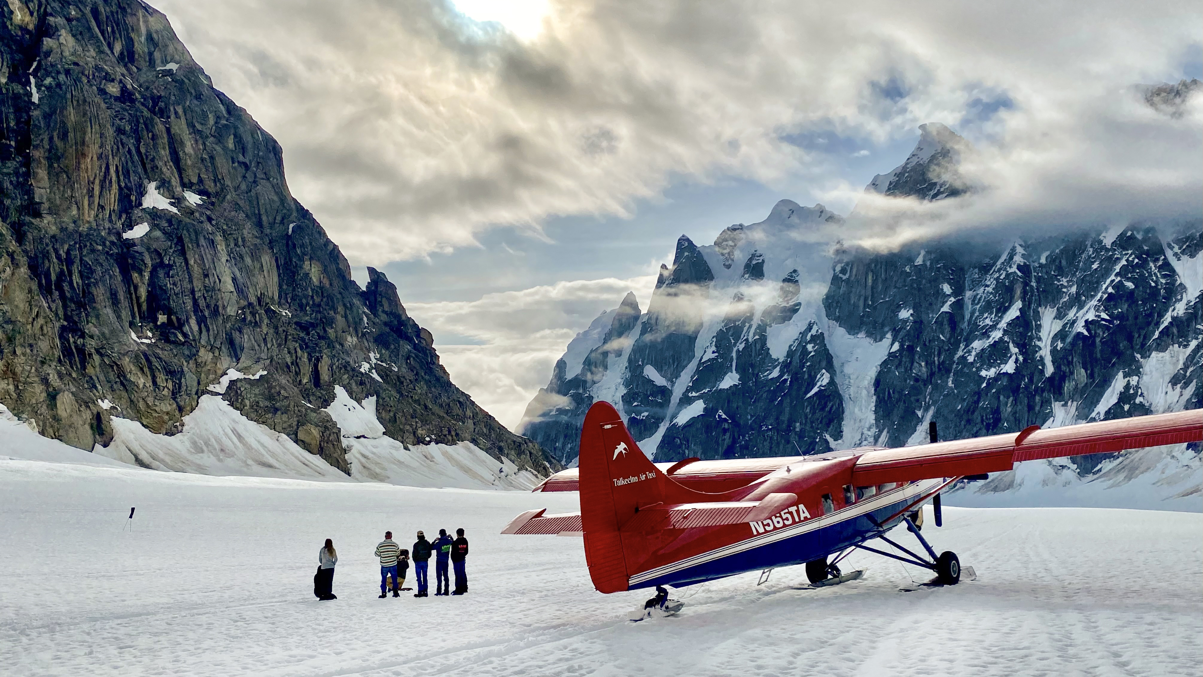 A Turbine Otter on the West Fork of Ruth Glacier in the Alaska Range on a June afternoon, with Rooster Comb peak in the background.