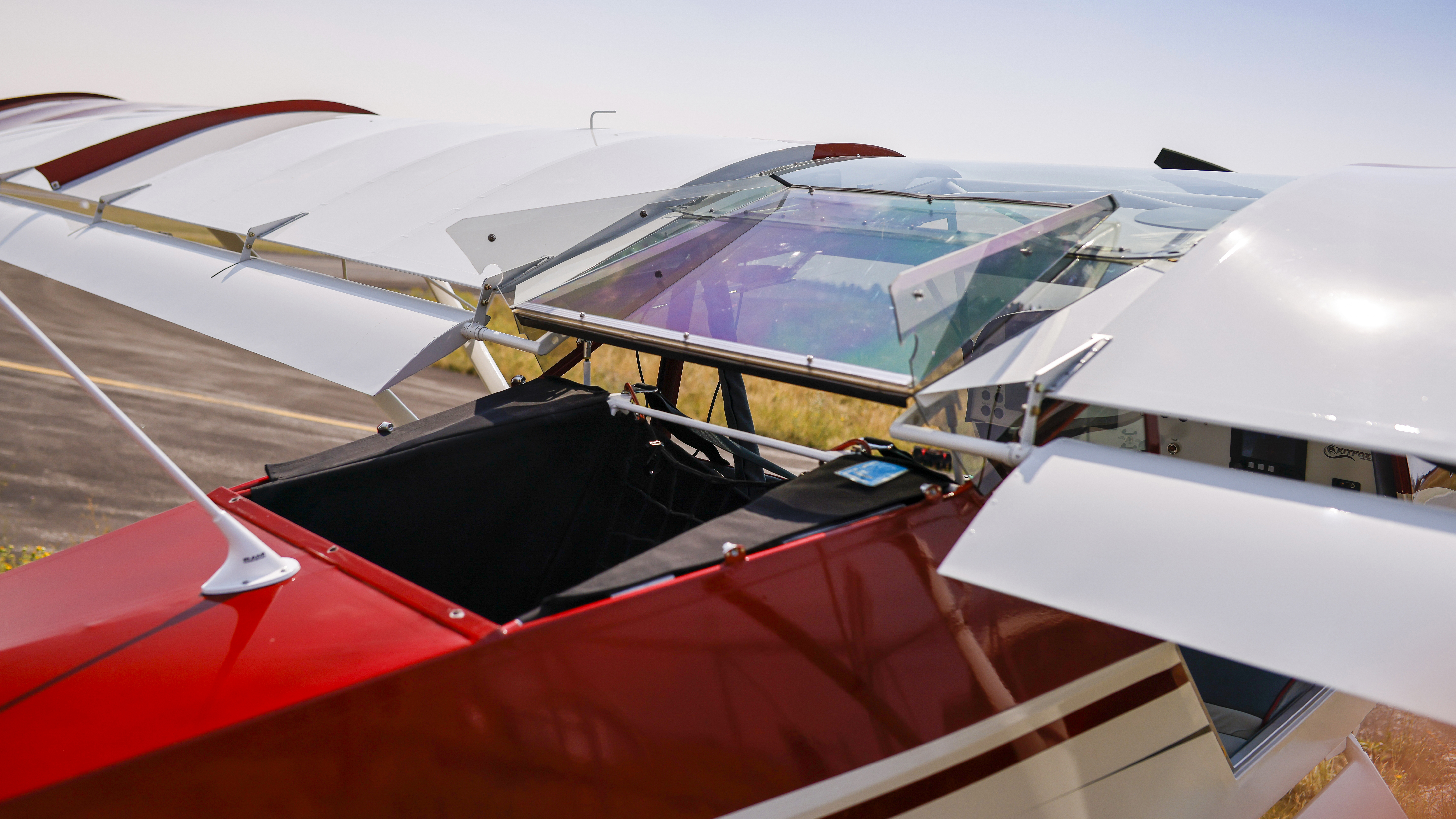 A tip-up baggage door provides easy access to the storage area behind the seats, and the compartment can hold up to 150 pounds of gear. Triangular vortex generators are visible on top of the wings, and the transparent doors can be removed for breezy but unobstructed flights.
