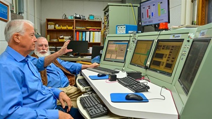 GAMI co-founders Tim Roehl and George Braly review engine performance data on a console that was originally used by NASA in Houston, Texas.
