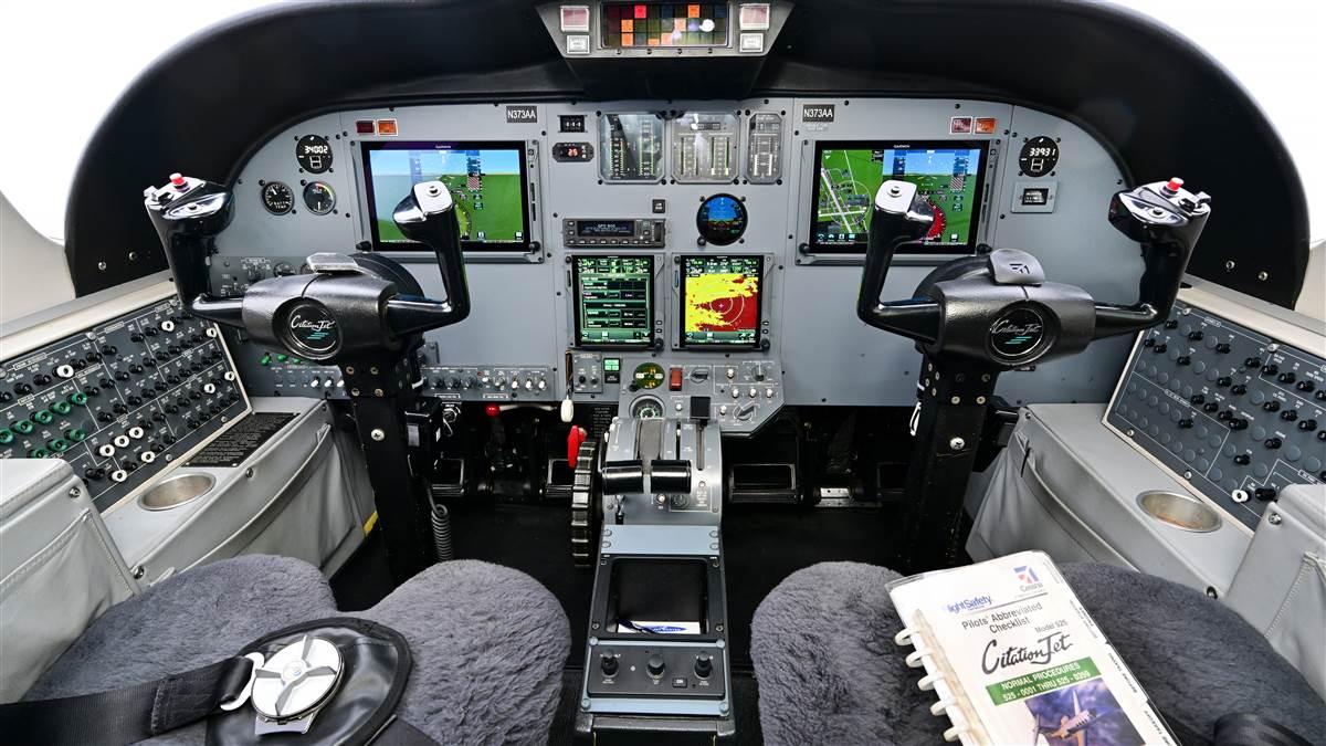 The upgraded panel is a mix of digital and analog. The colorful, touchscreen Garmin displays as well as the standby instrument and autopilot are new, but the engine gauges and angle-of-attack indicator are original. The annunciator panel at the top/center of the instrument panel is original, too.