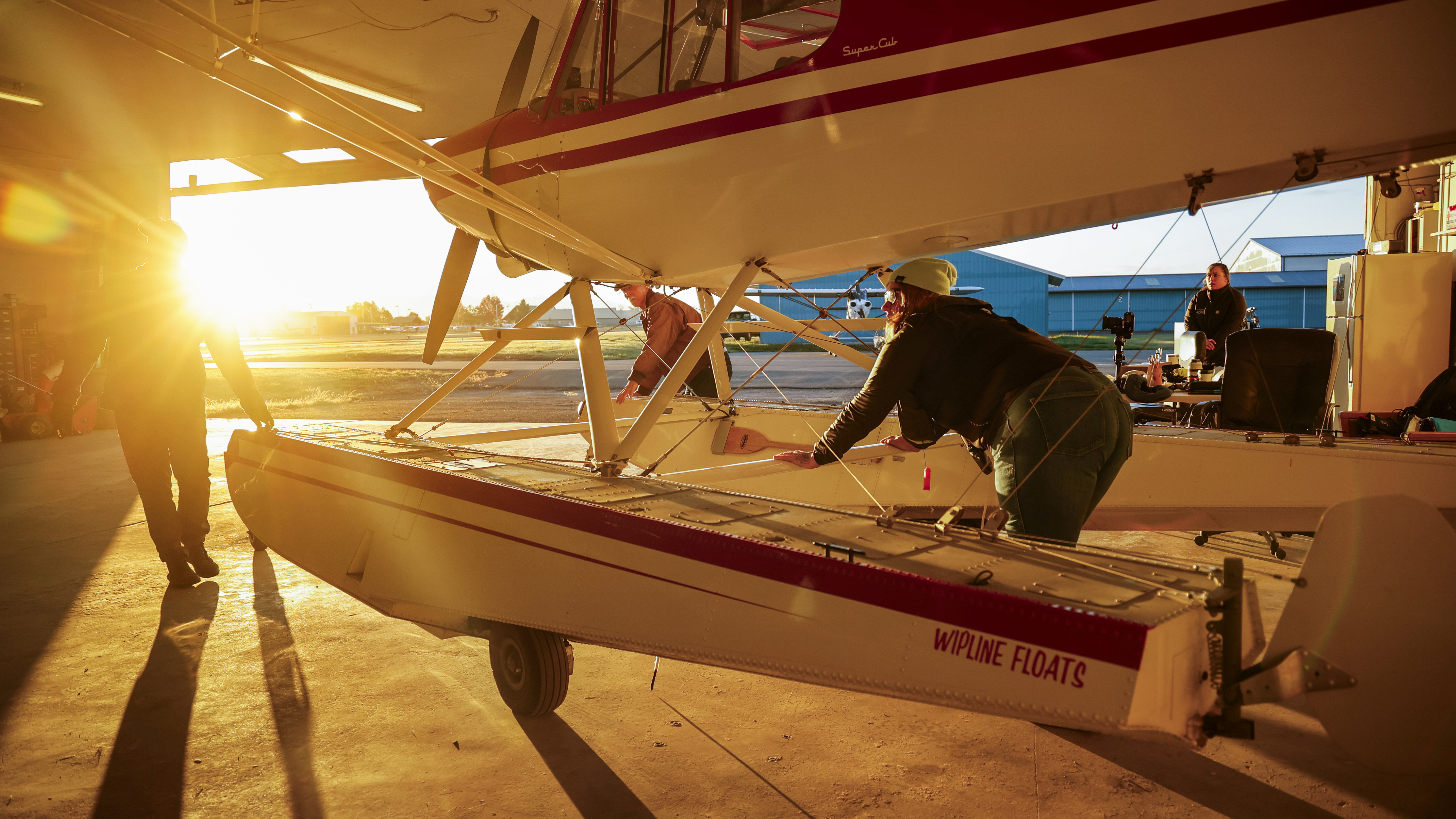 The Backcountry team pushes their Super Cub on amphibs out of the hangar at Kalispell City Airport. Photo by Chris Rose