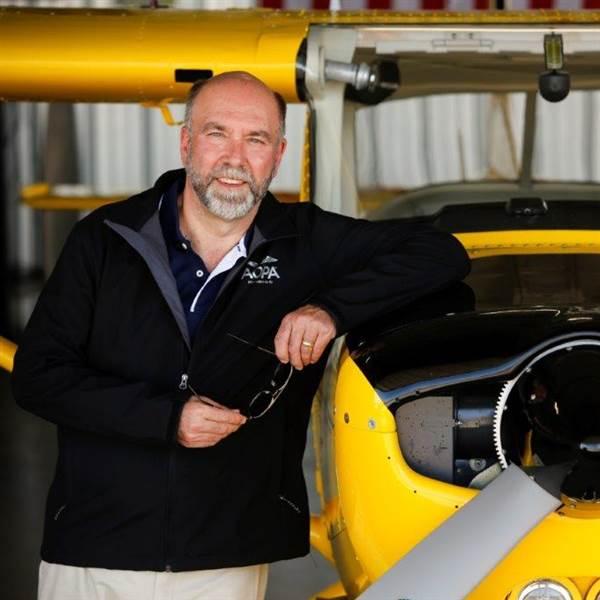 photo of andy miller next to a yellow cessna