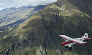 Husky aircraft flying near mountain range