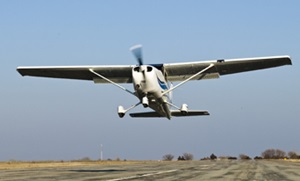 Cessna 172 taking off from a runway straight on view