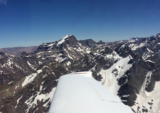 The craggy peaks of the Andes Mountains are framed by the wing of Tomas Vykruta's Cirrus SR22 near Santiago, Chile. Photo courtesy of FlyforMS.org.