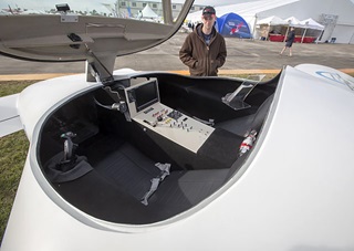 The Commuter Craft Innovator, a roadable two-seater with a pusher prop, a canard, and four lifting surfaces, draws curious looks at the U.S. Sport Aviation Expo in Sebring, Florida.