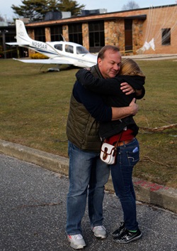 Father and daughter exchange a hug after safely deplaning from their Cirrus SR22 following a parachute deployment March 5. Photo by Victor Alcorn, courtesy of www.victoralcorn.com