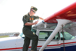 A Marine Military Academy cadet preflights a Cessna 172.