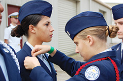 A Central Florida Aerospace Academy junior ROTC cadet bestows a new rank on another cadet.