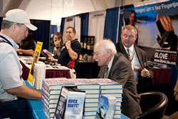 Hall of Fame pilot Bob Hoover signs copies of Forever Flying< at the 2010 AOPA Summit.