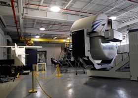 The Gyrolab, at right, is a single-seat centrifuge-based motion simulator with a cockpit inside, and able to deliver sustained G force.