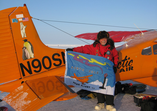 Art Mortvedt holds a flag at a Russian research station 20 miles from 90 degrees north, having overflown the pole April 6, 2013. Photo courtesy Art Mortvedt.