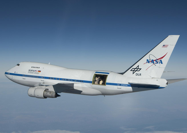 NASA’s Stratospheric Observatory for Infrared Astronomy is mounted in a highly modified Boeing 747, fitted with an open door to the atmosphere and pressure barriers that protect passengers and crew from the elements at 45,000 feet. NASA photo.
