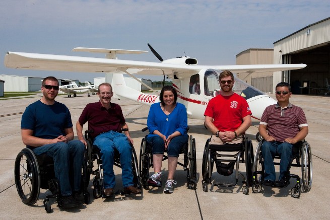 Able Flight awarded pilot wings to six new pilots at AirVenture. Shown here, left to right, are Warren Cleary, Dennis Akins, Dierdre Dacey, Andrew Kinard, and Young Choi. Not shown is Stephany Glassing. 
