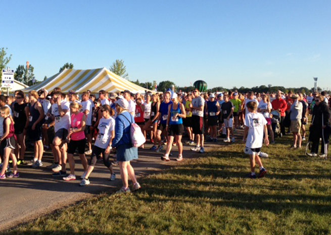 Nearly 700 people participated in the EAA AirVenture Runway 5K Run/Walk. Photo by Bruce Douglas.