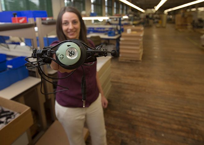 David Clark Co. Senior Mechanical Engineer Melissa Banks holds a DC PRO-X at the factory.