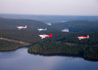 Four RV-8s on an evening practice flight.