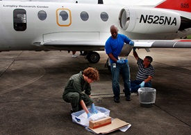 NASA Langley researchers remove the coatings once they have flown on the airplane wings and delicately pack them away for possible further study. Credit: NASA Langley/David C. Bowman