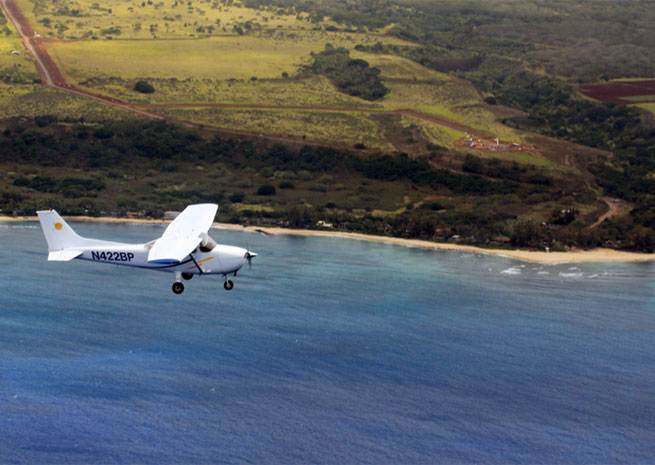A Cessna 172 available from Barber’s Point Flight School over the North Shore of Oahu.