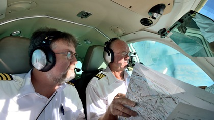 Mike Laver, right, and Mike Collins check their charts as they navigate between Syrian and Iranian airspace. In this part of the world, even general aviation pilots have to dress for the part. Photo by Mike Collins.