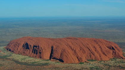 Ayers Rock, also called Uluru, in central Australia is a 550-million-year-old sandstone monolith. Like the Grand Canyon, there is a charted aerial tour route. Photo by Mike Collins.
