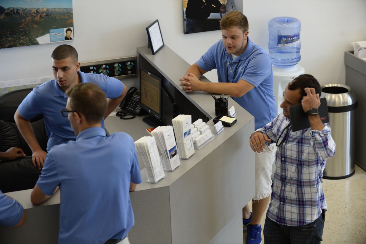 3 people at a front desk