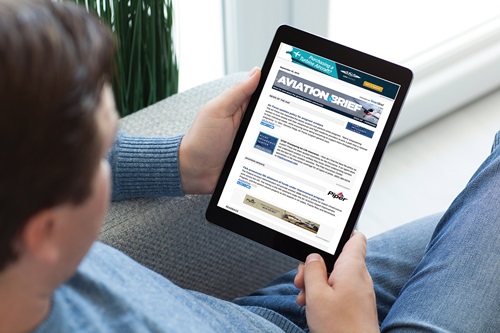 man in jeans on sofa holding tablet computer with app tracking delivery package