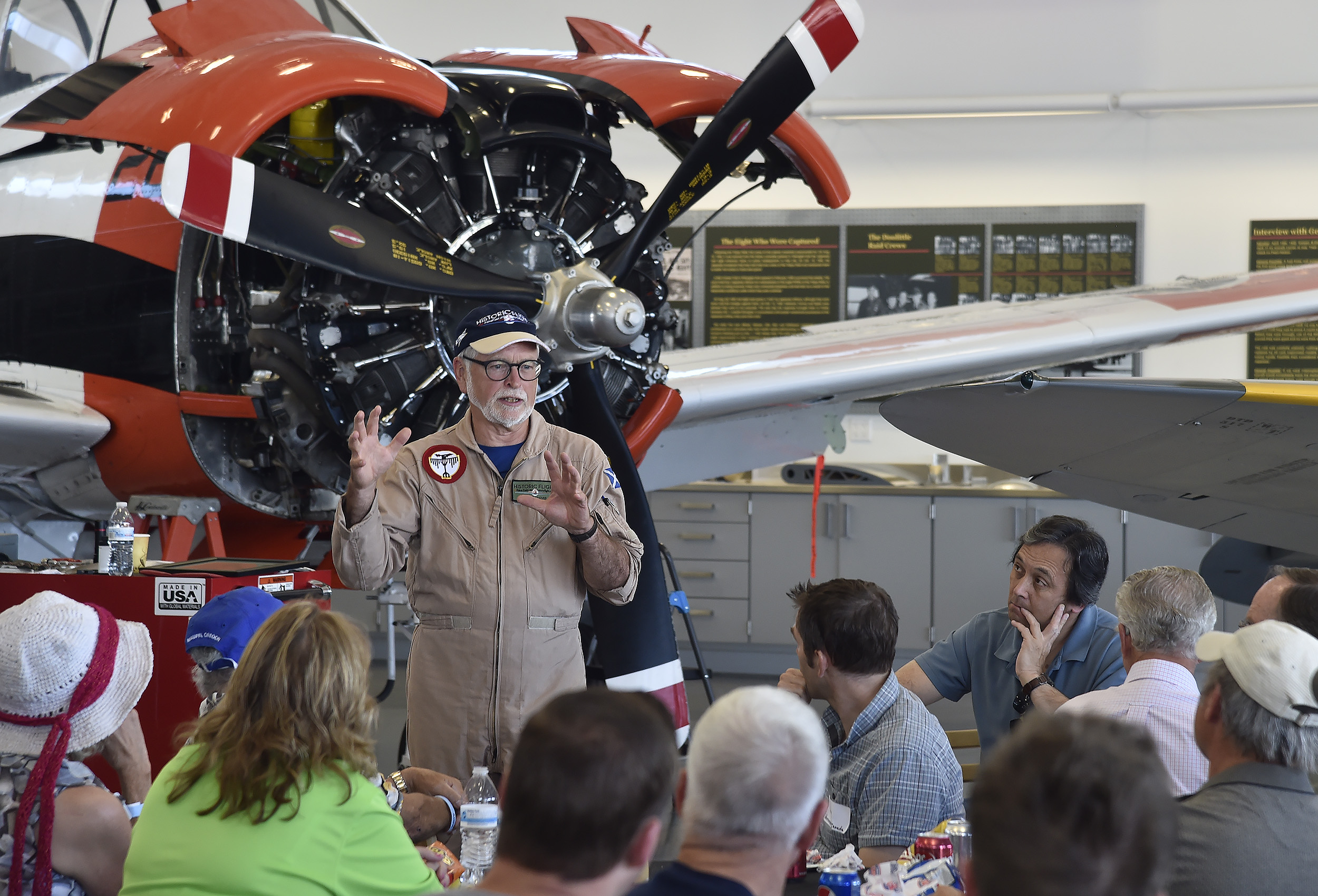 Historic Flight Foundation's John Sessions holds tour participants' attention at Paine Field in Everett, Washington, during a lunch stop for AOPA Bremerton Fly-In attendees participating in a special Boeing VIP tour Aug. 19. Photo by David Tulis.
